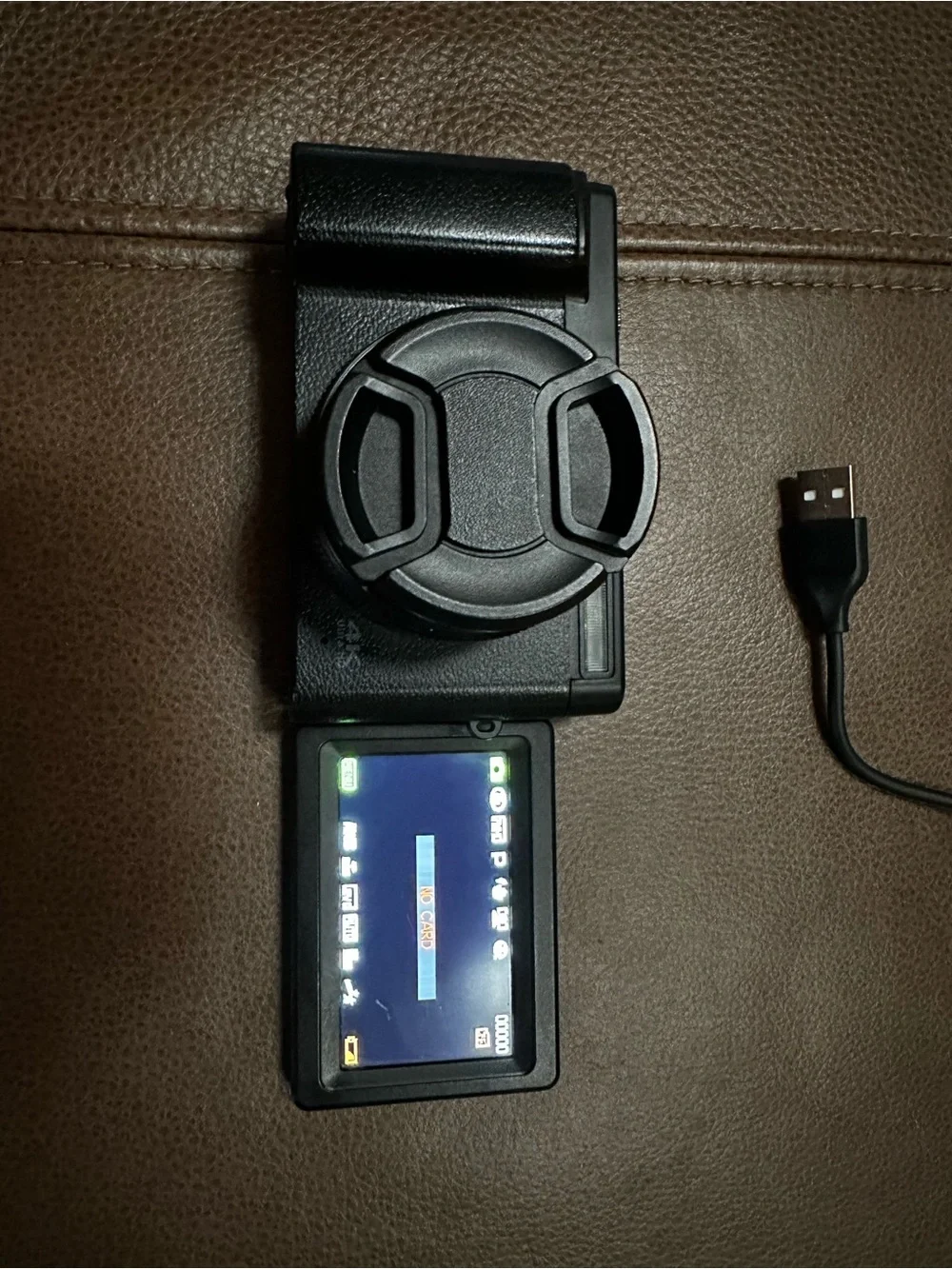 Compact Black Digital Camera with USB Cable and Lens Cap